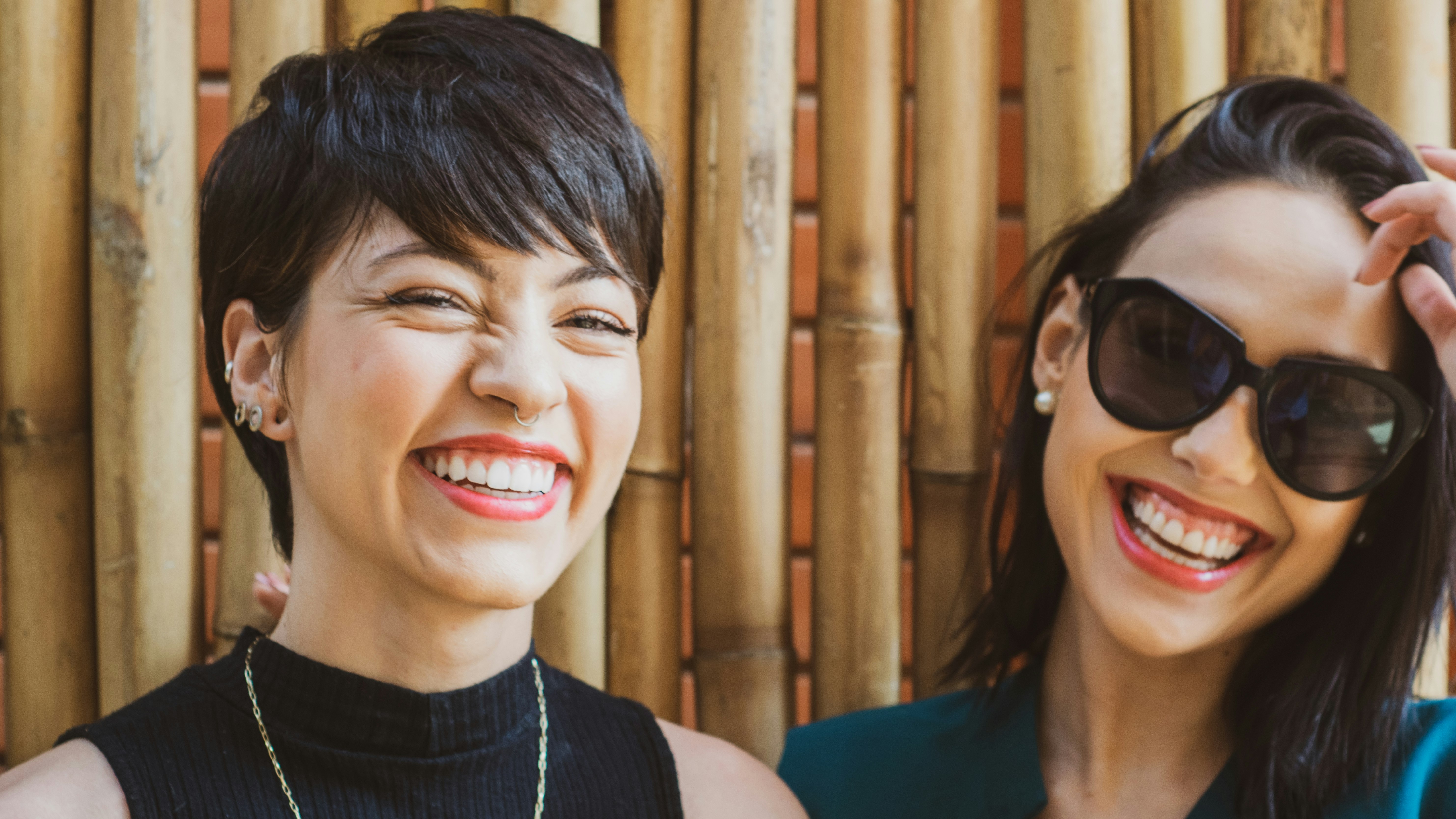 two women standing and laughing